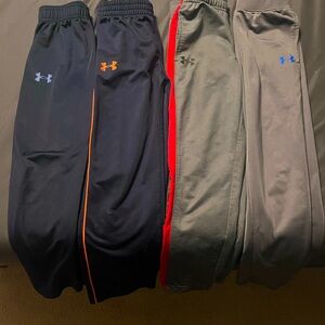 4 pairs of Under Armour Boys Pants. All size 7. Two navy, two gray.
